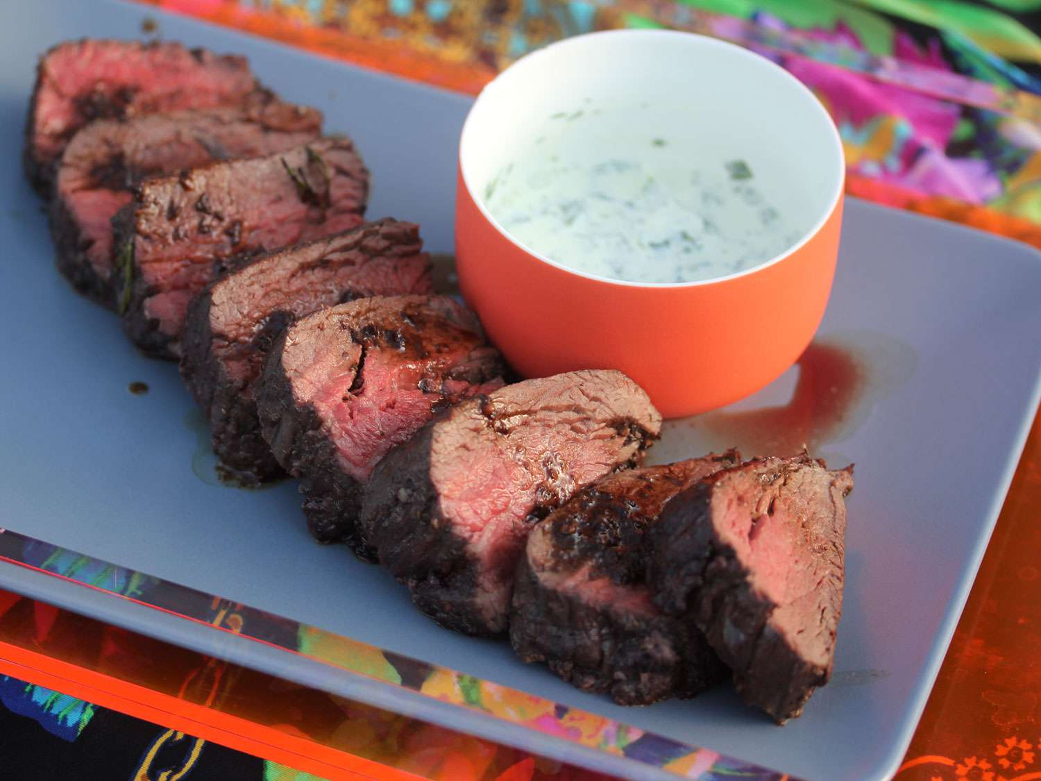 A platter of red-wine marinated roasted beef tenderloin with horseradish sauce.