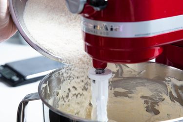 Pouring flour into stand mixer bowl