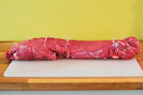 A beef tenderloin trimmed of fat and tied with twine.
