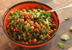 bowl of roasted chickpea, sun-dried tomato, herb, and kale salad with pine nuts