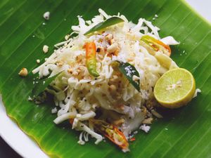 Quick Indian Cabbage Salad on a banana leaf with half a lime.