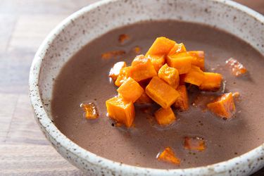 A bowl of Cherokee pureed nut soup topped with sweet potato