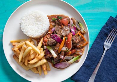 overhead view of lomo saltado plated with french fries and white rice